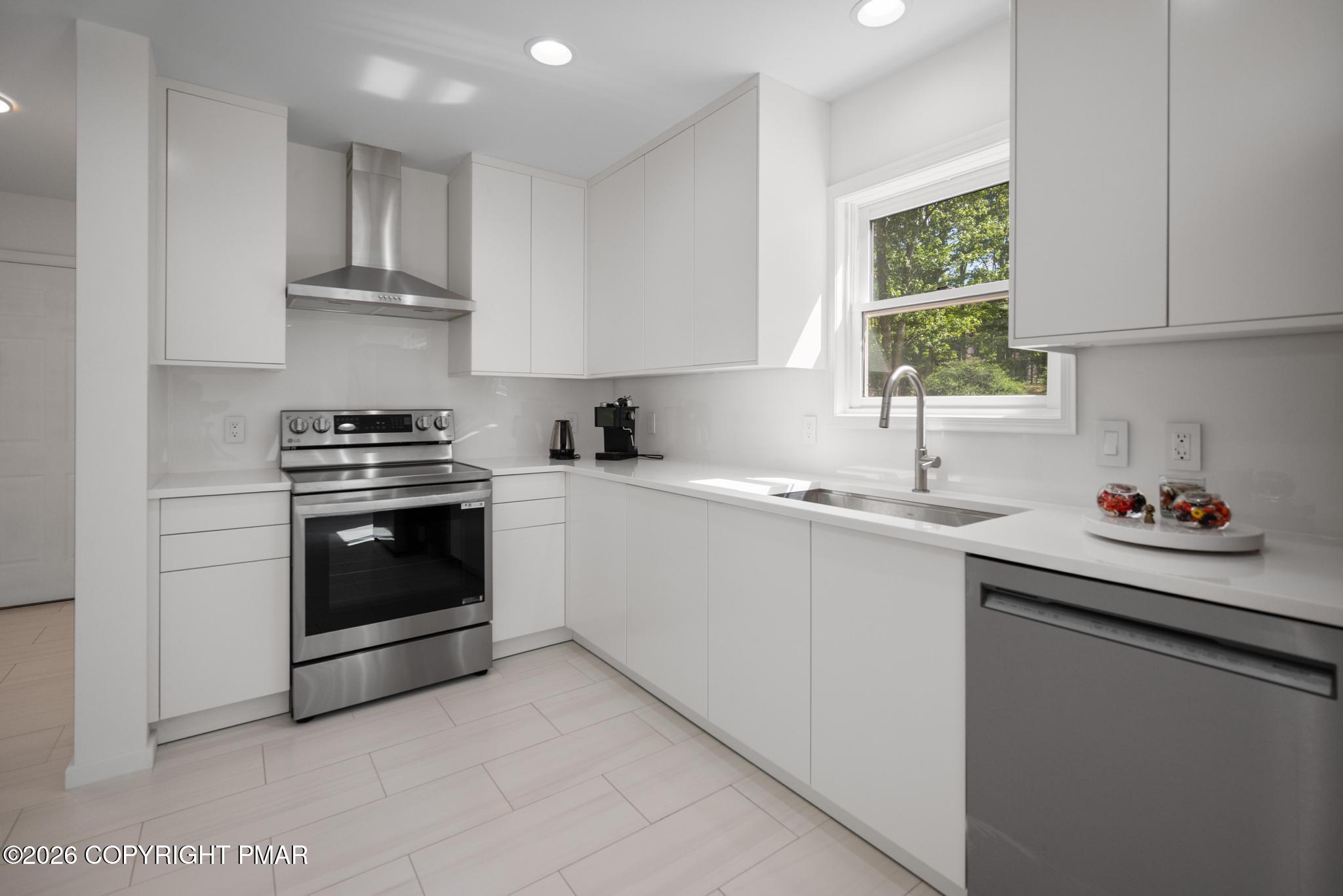 2312 Cramer Court Bushkill, PA 18324 - Photo 11 of 37 a kitchen with granite countertop a sink cabinets stainless steel appliances and a window