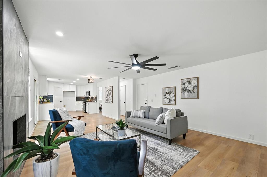 6218 Everglade Road Dallas, TX 75227 - Photo 19 of 39 Living area with a ceiling fan, light wood-style flooring, a large fireplace, and recessed lighting