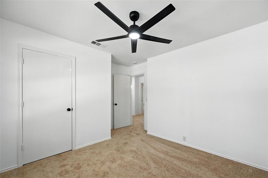 6218 Everglade Road Dallas, TX 75227 - Photo 27 of 39 Unfurnished bedroom featuring light colored carpet and ceiling fan