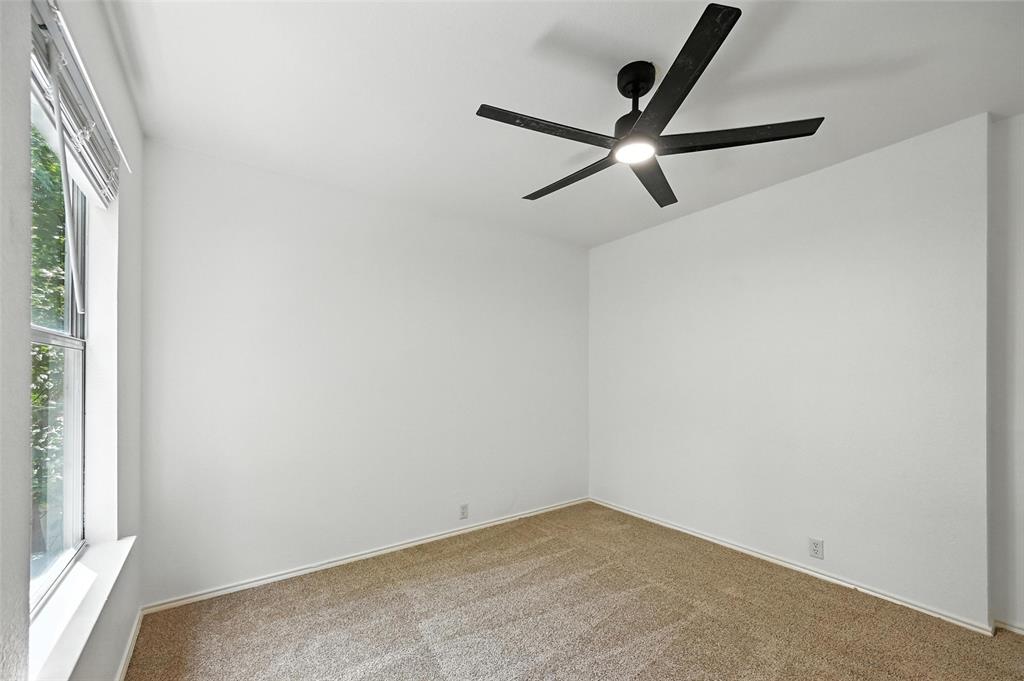 6218 Everglade Road Dallas, TX 75227 - Photo 30 of 39 Carpeted empty room featuring a ceiling fan and baseboards