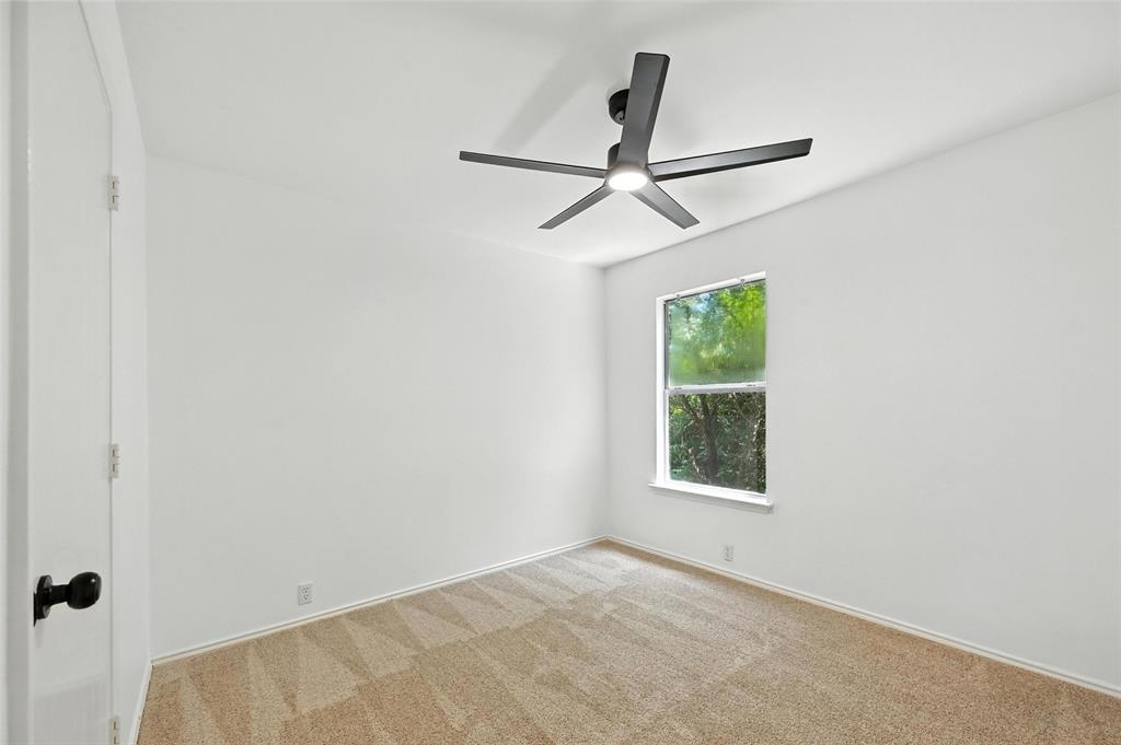 6218 Everglade Road Dallas, TX 75227 - Photo 31 of 39 Empty room featuring a ceiling fan and carpet