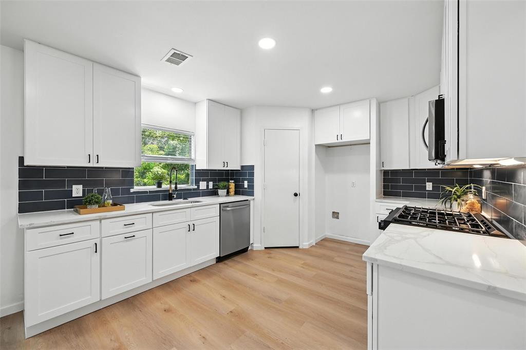 6218 Everglade Road Dallas, TX 75227 - Photo 9 of 39 Kitchen with stainless steel appliances, tasteful backsplash, light wood finished floors, light stone countertops, and recessed lighting