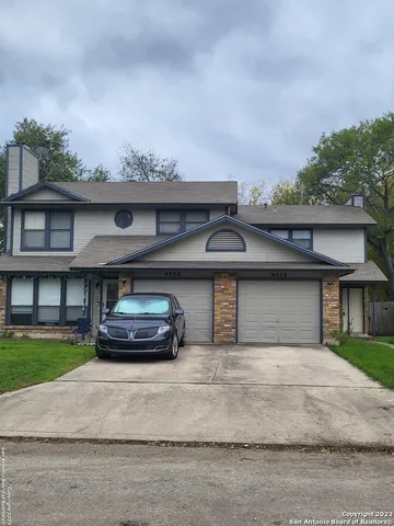 a car parked in front of white house
