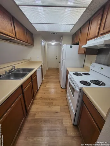 a kitchen with a stove and a sink