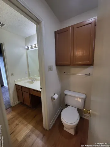 a bathroom with a toilet a sink and mirror