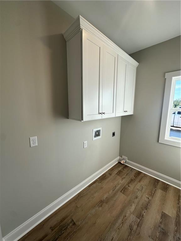 5207 Lee Road Salem, AL 36874 - Photo 17 of 23 Laundry room featuring dark wood-type flooring, cabinet space, hookup for a washing machine, and hookup for an electric dryer