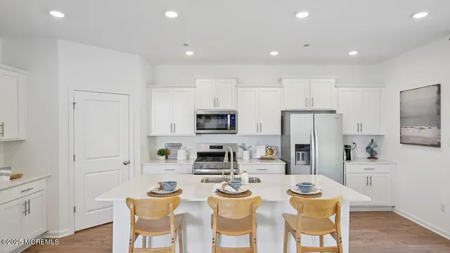 a open kitchen with stainless steel appliances granite countertop a lot of counter space and wooden floors