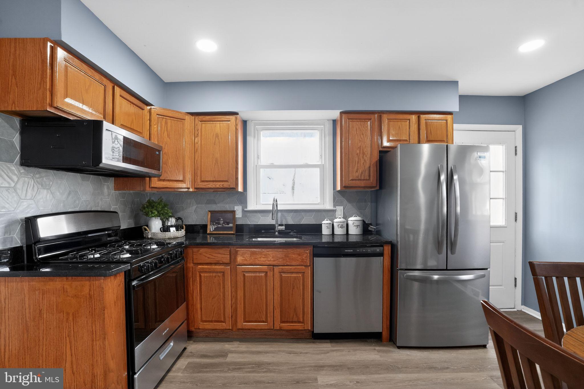 218 East Somerdale Road Somerdale, NJ 08083 - Photo 12 of 30 a kitchen with granite countertop a refrigerator stove top oven a sink and dishwasher