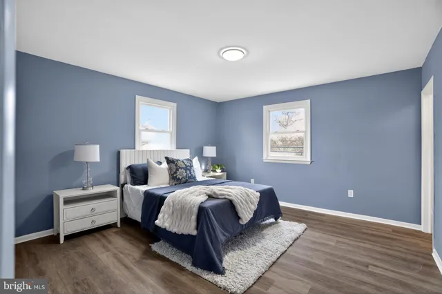 a bedroom with a bed and a night stand