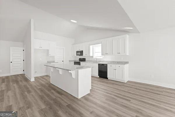 a kitchen with white cabinets and white appliances
