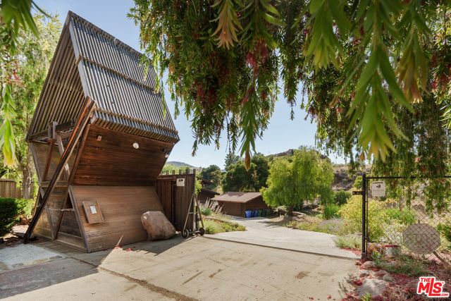 a view of a house with a tree