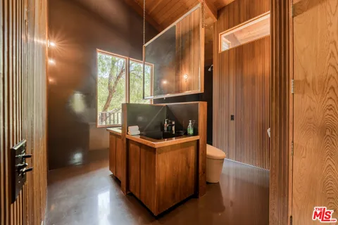 a view of a patio with couches table and chairs and potted plants