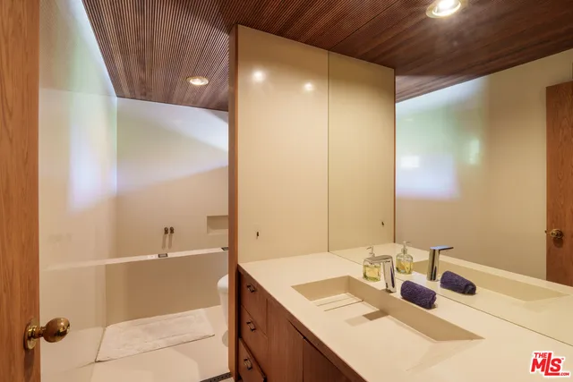 a bathroom with a tub sink and mirror