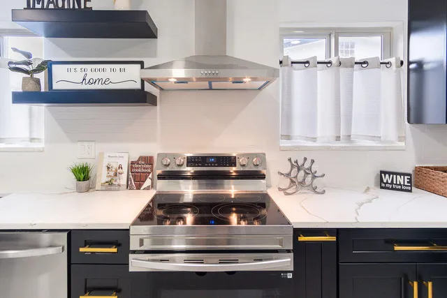 a kitchen with a stove oven and potted plant