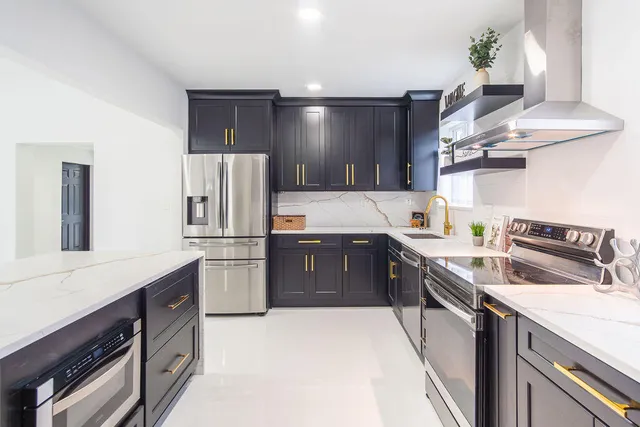 a kitchen with stainless steel appliances a sink stove and cabinets