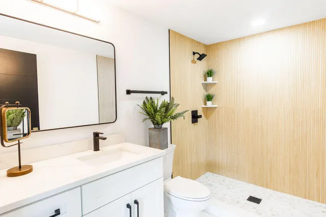 a view of a living room with a sink and a mirror