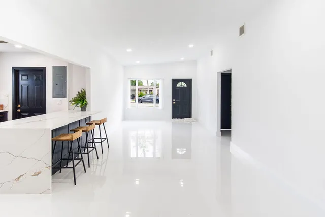 a kitchen with stainless steel appliances kitchen island wooden cabinets and refrigerator