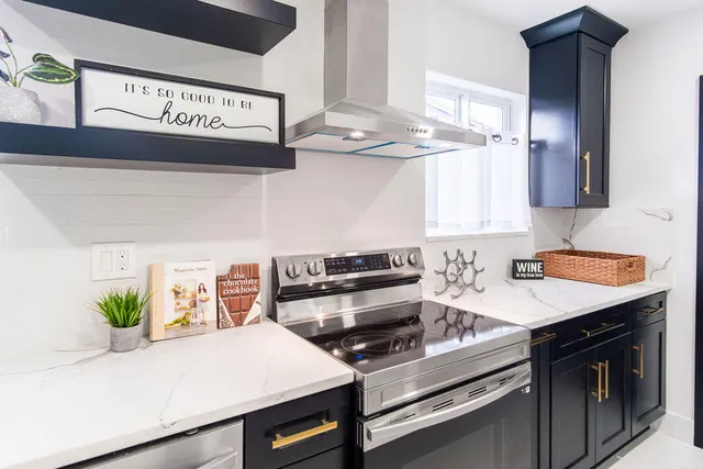 a stove top oven sitting inside of a kitchen