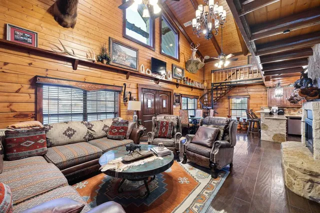 a view of a patio with couches table and chairs and potted plants