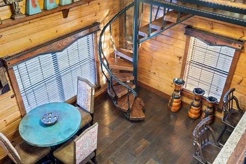a view of a porch with wooden floor and furniture