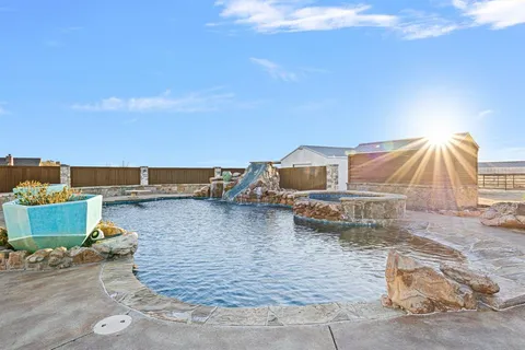 a dining room with a wooden table and chairs