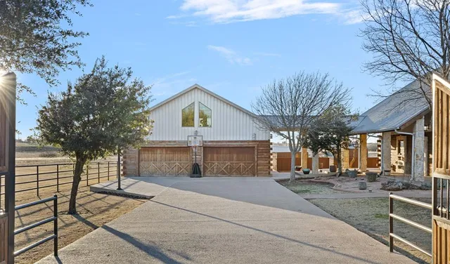 a front view of a house with a yard and trees