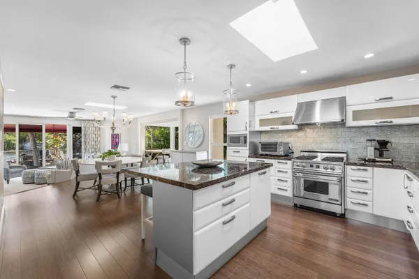 a kitchen with lots of counter top space and painting on the wall