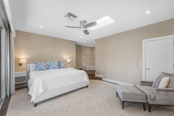 a bedroom with a bed and ceiling fan