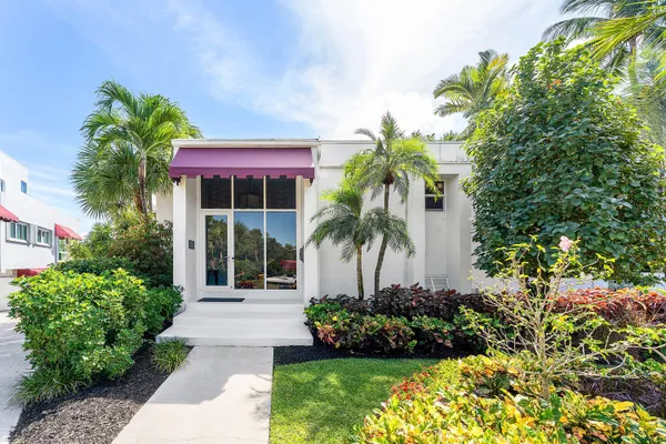 a view of a lake with boats and trees in the background