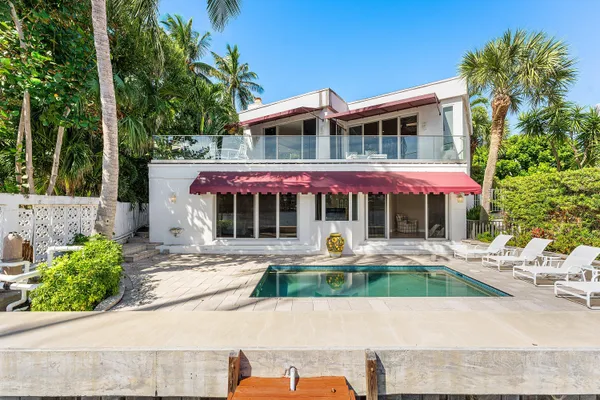 a view of a swimming pool with sitting area
