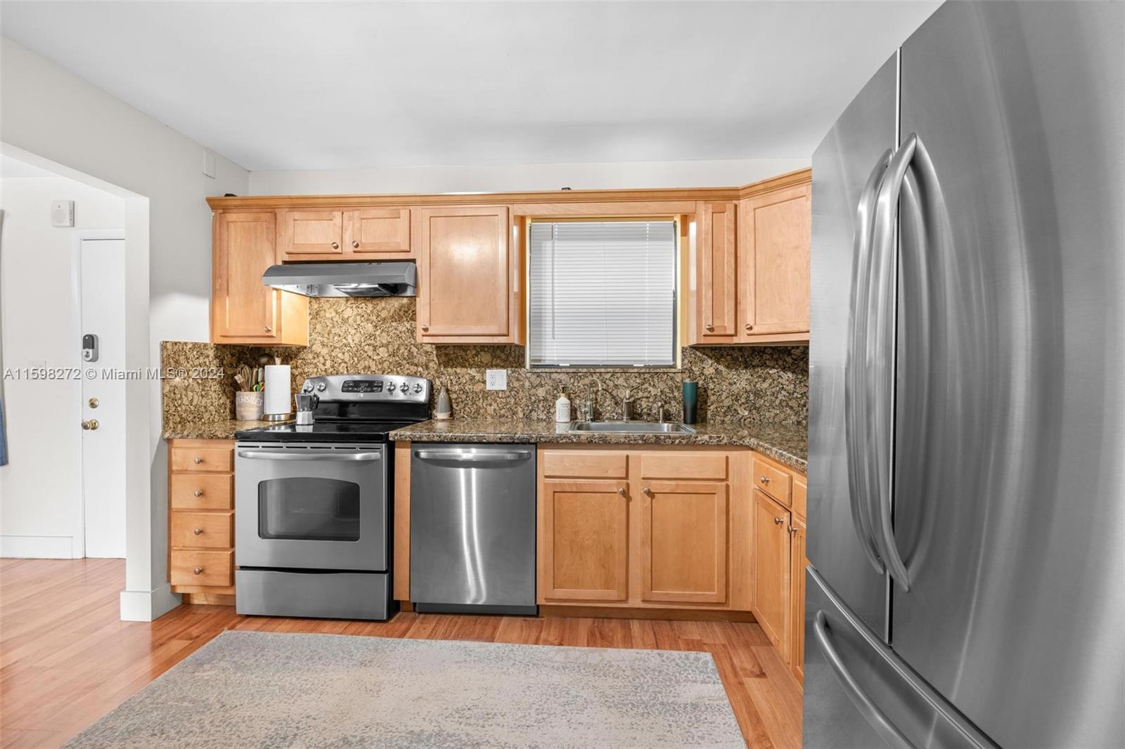 605 Ives Dairy Road, Unit 3047 Miami, FL 33179 - Photo 15 of 39 a kitchen with stainless steel appliances granite countertop a refrigerator and a stove top oven