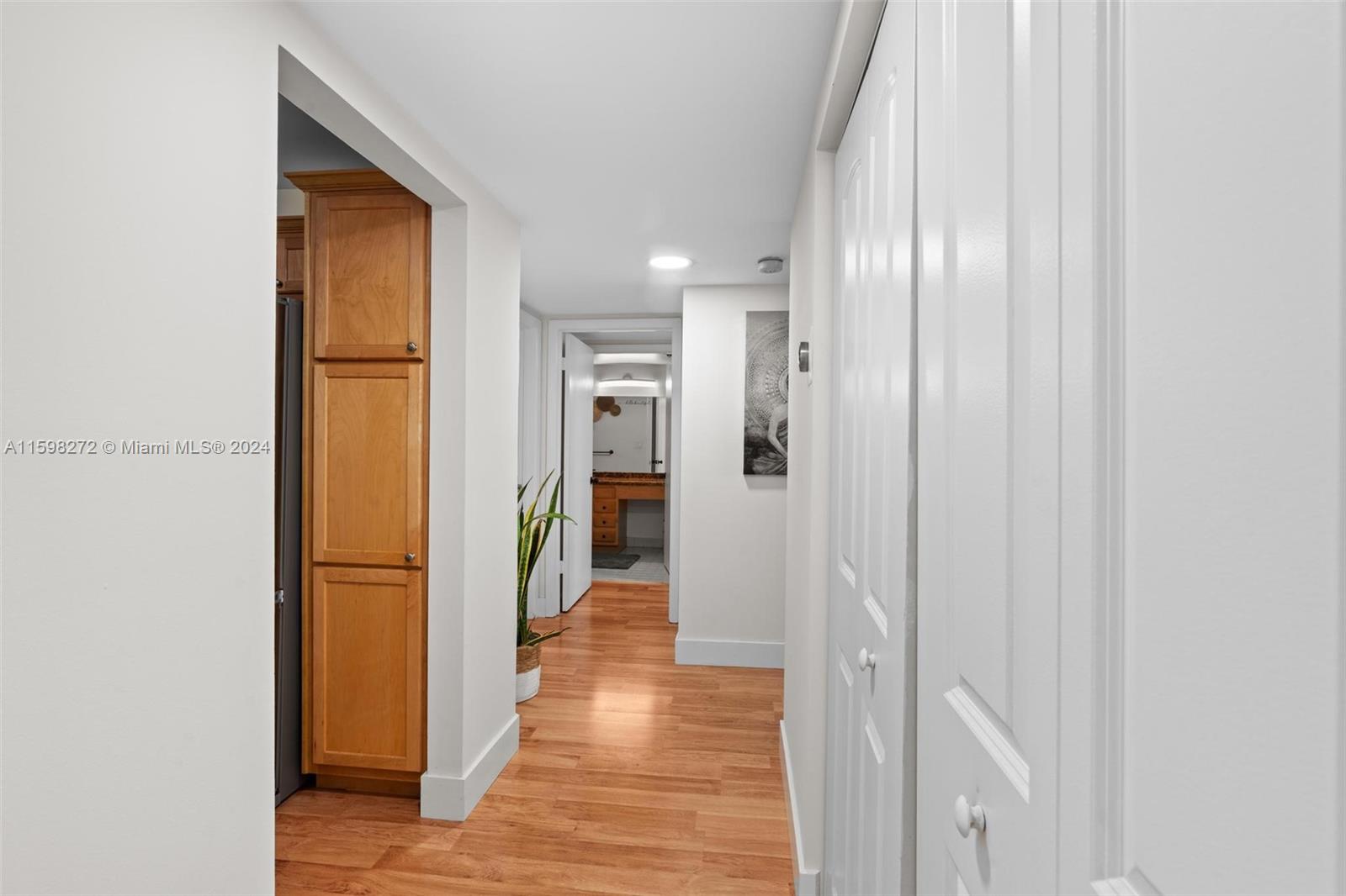 605 Ives Dairy Road, Unit 3047 Miami, FL 33179 - Photo 16 of 39 a view of a hallway with wooden floor