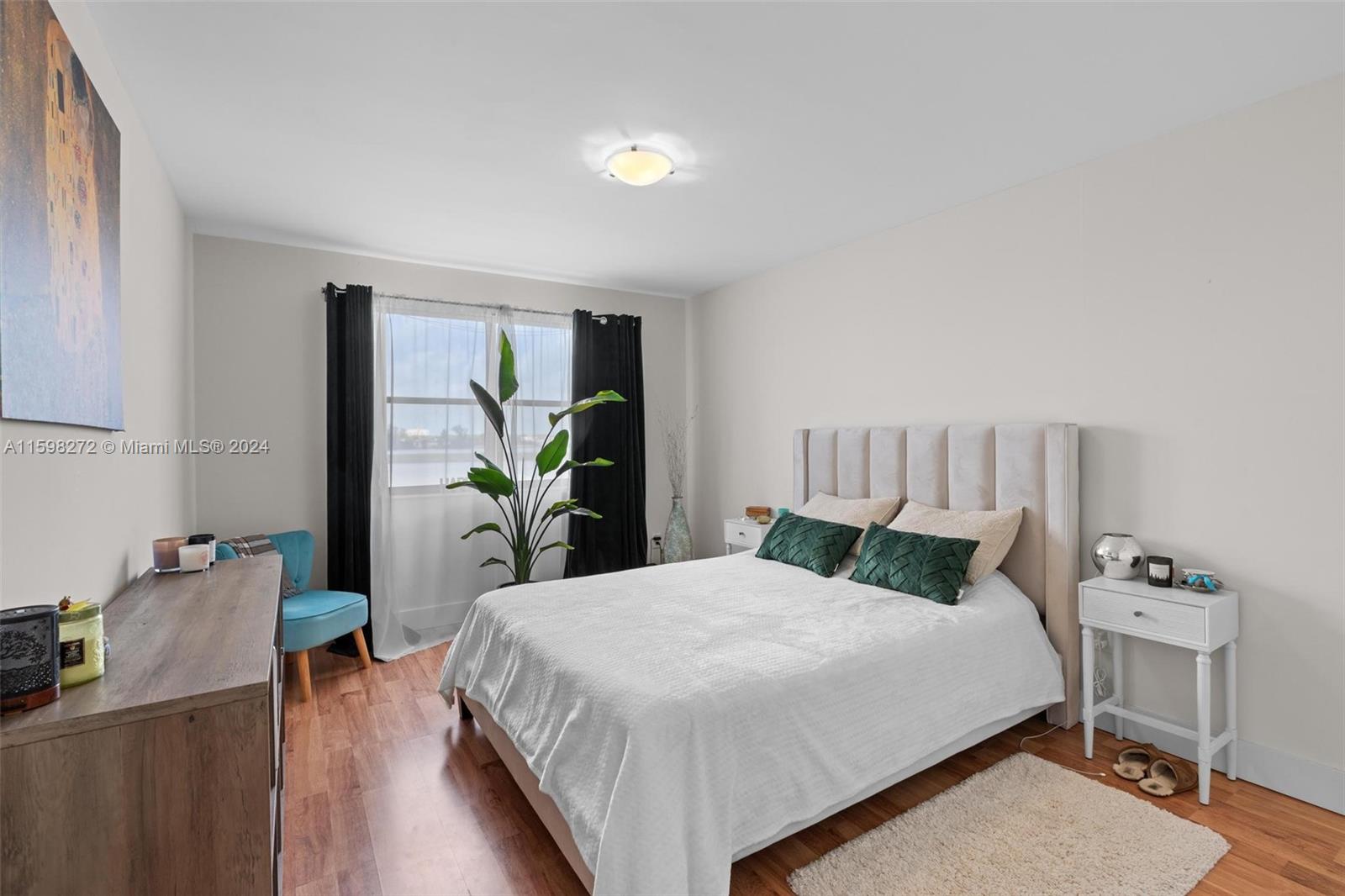 605 Ives Dairy Road, Unit 3047 Miami, FL 33179 - Photo 17 of 39 a bedroom with a bed and a table