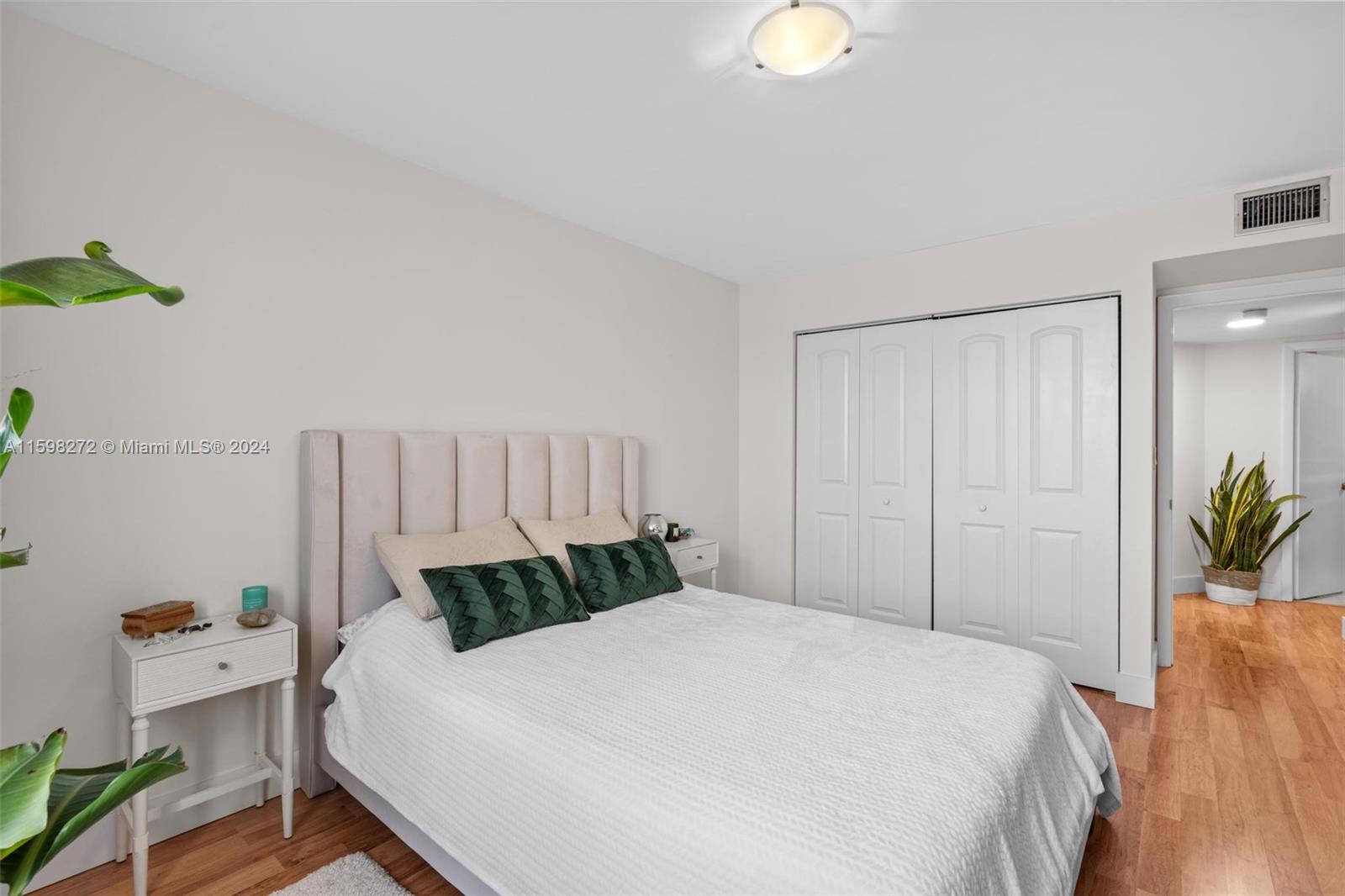 605 Ives Dairy Road, Unit 3047 Miami, FL 33179 - Photo 18 of 39 a bedroom with a bed and a chandelier