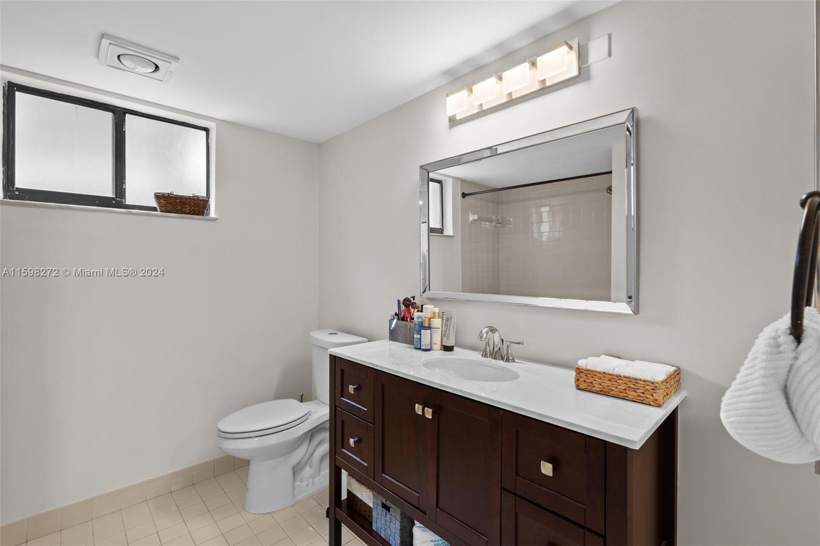 605 Ives Dairy Road, Unit 3047 Miami, FL 33179 - Photo 19 of 39 a bathroom with a toilet a sink a vanity and mirror