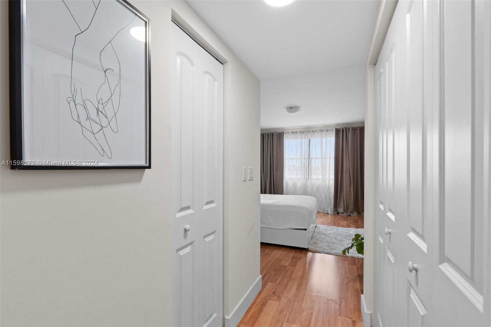 605 Ives Dairy Road, Unit 3047 Miami, FL 33179 - Photo 21 of 39 a view of a hallway with wooden floor and cabinet