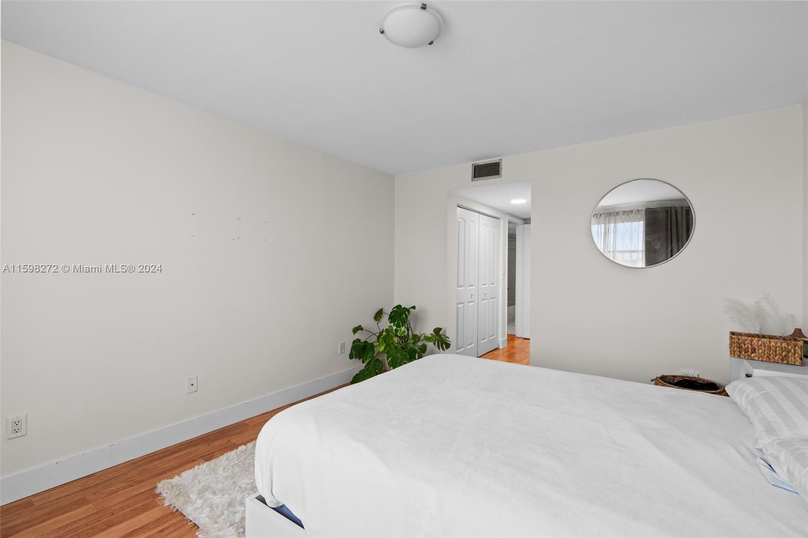 605 Ives Dairy Road, Unit 3047 Miami, FL 33179 - Photo 23 of 39 a bed room with a bed and a chandelier