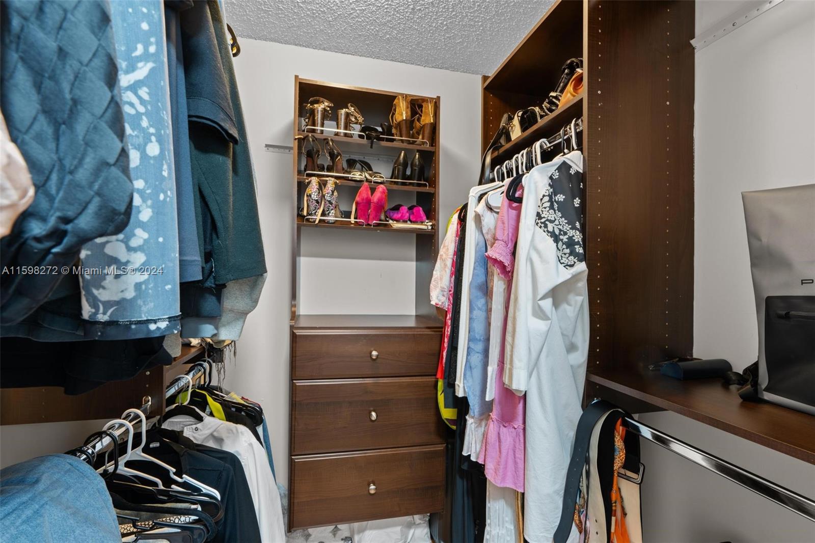 605 Ives Dairy Road, Unit 3047 Miami, FL 33179 - Photo 24 of 39 a view of walk in closet with clothes