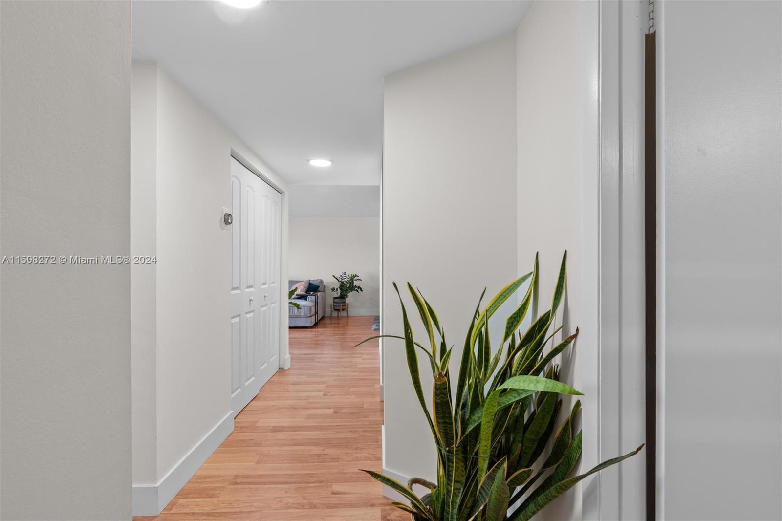 605 Ives Dairy Road, Unit 3047 Miami, FL 33179 - Photo 28 of 39 a view of a hallway with wooden green walls