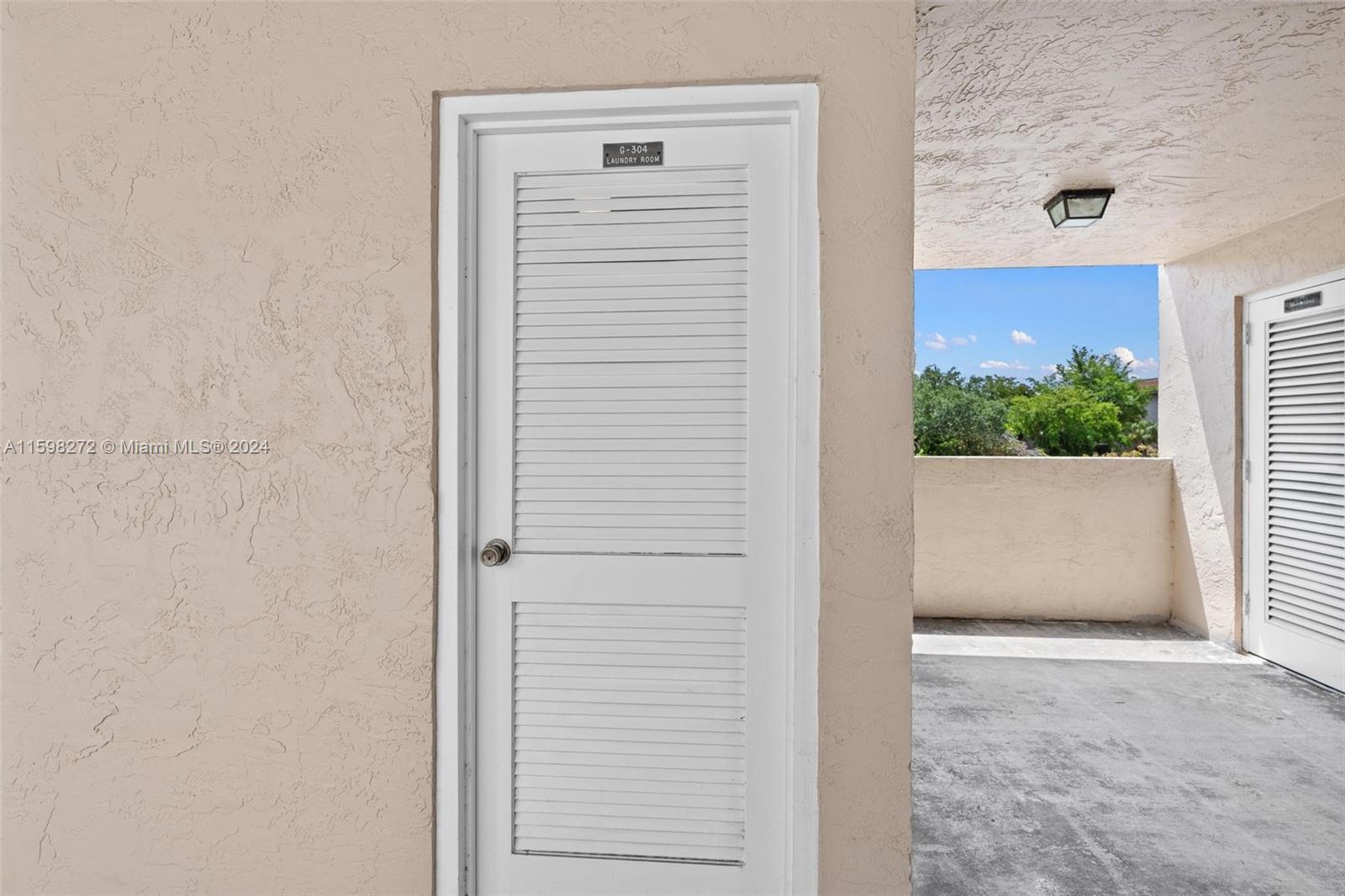 605 Ives Dairy Road, Unit 3047 Miami, FL 33179 - Photo 31 of 39 a view of front door and potted plants