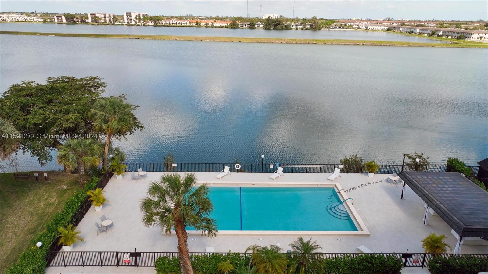605 Ives Dairy Road, Unit 3047 Miami, FL 33179 - Photo 35 of 39 a view of a lake with couches and chairs
