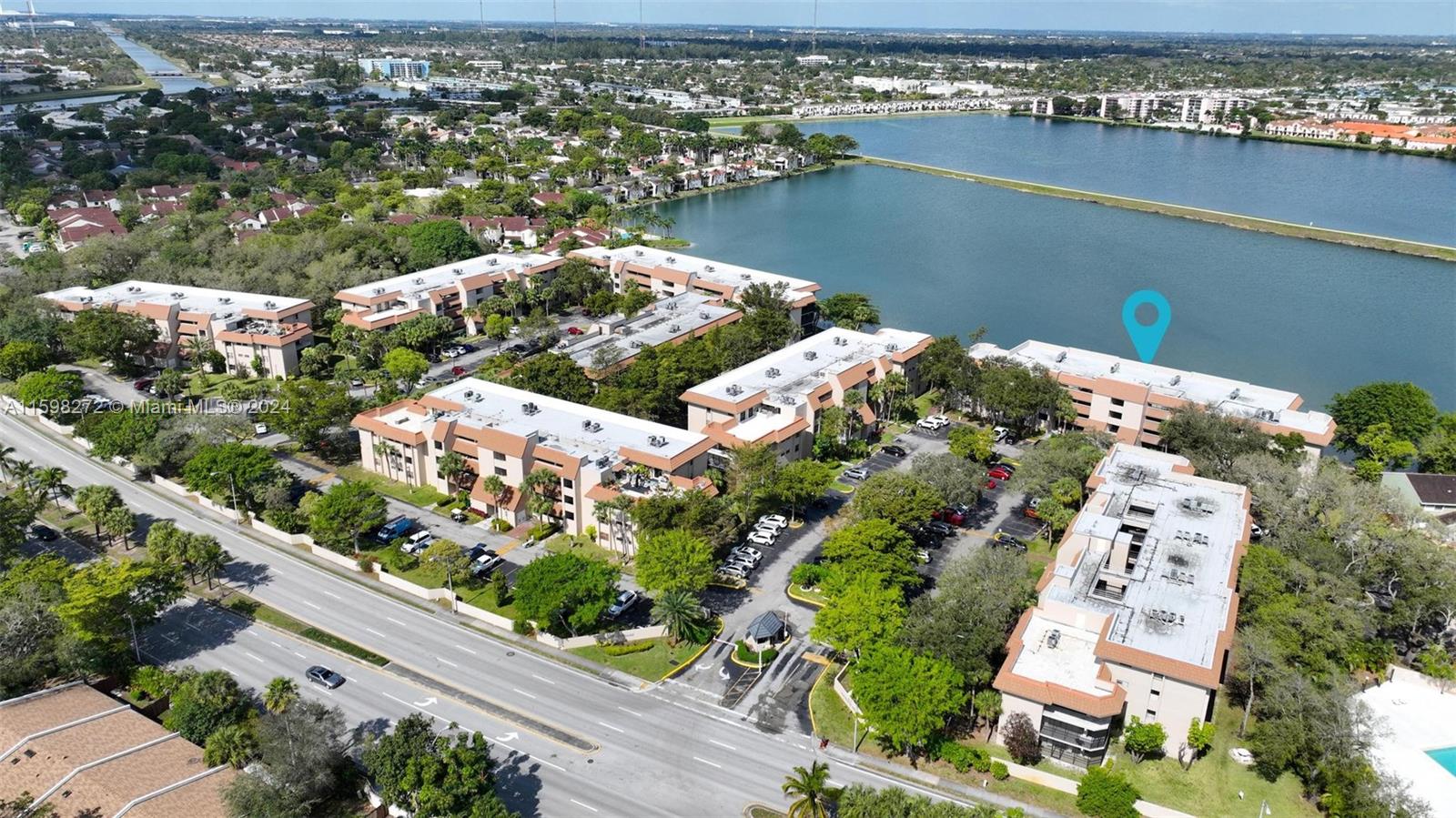 605 Ives Dairy Road, Unit 3047 Miami, FL 33179 - Photo 37 of 39 an aerial view of lake and residential houses with outdoor space