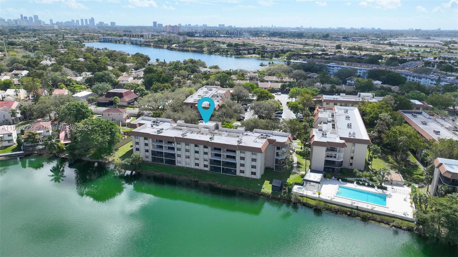 605 Ives Dairy Road, Unit 3047 Miami, FL 33179 - Photo 39 of 39 an aerial view of lake and residential houses with outdoor space and swimming pool