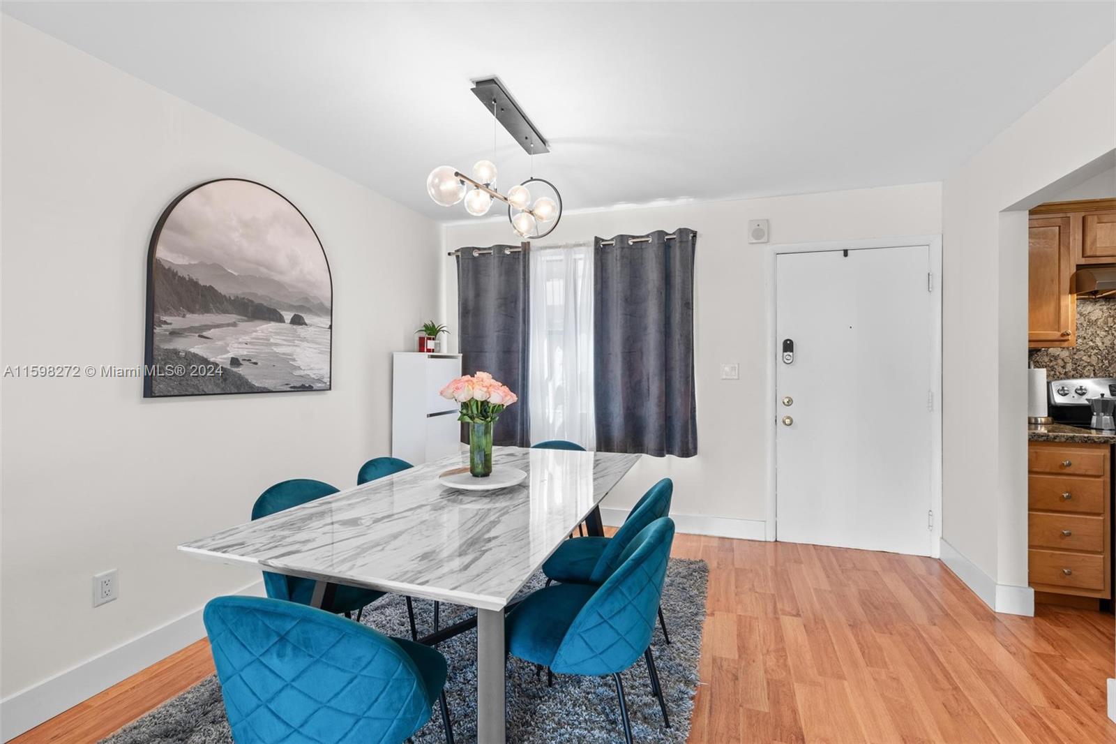 605 Ives Dairy Road, Unit 3047 Miami, FL 33179 - Photo 4 of 39 a view of a dining room with furniture and wooden floor