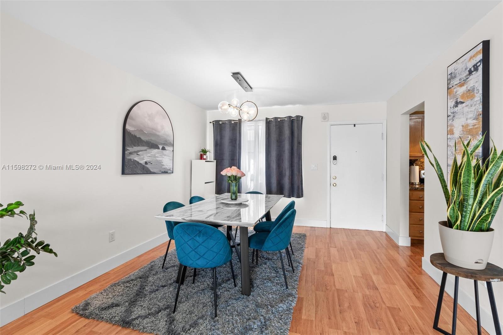 605 Ives Dairy Road, Unit 3047 Miami, FL 33179 - Photo 5 of 39 a dining room with furniture potted plants and wooden floor
