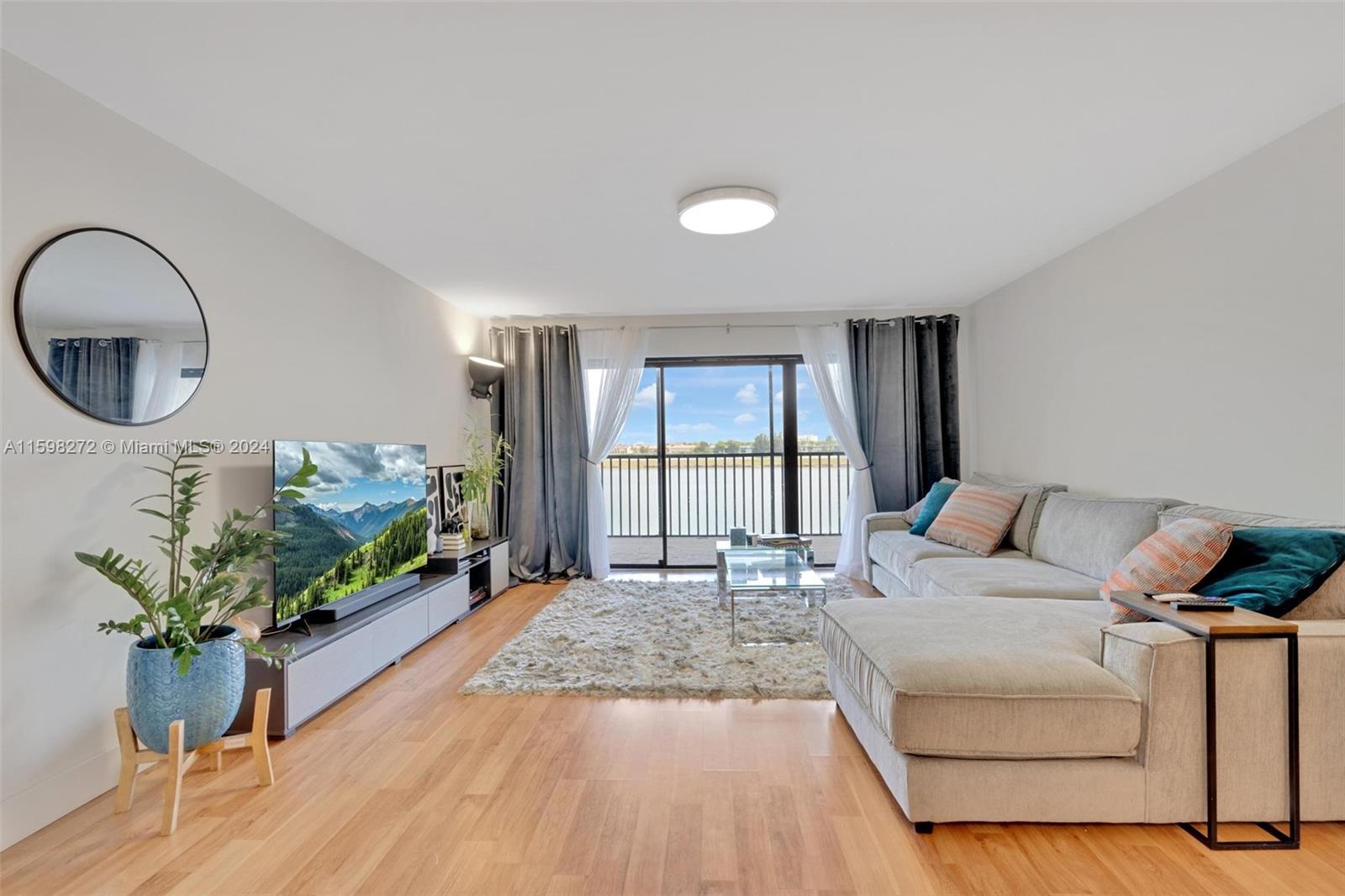 605 Ives Dairy Road, Unit 3047 Miami, FL 33179 - Photo 7 of 39 a living room with furniture windows and a potted plant