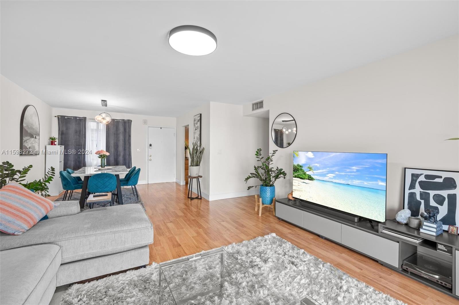 605 Ives Dairy Road, Unit 3047 Miami, FL 33179 - Photo 10 of 39 a living room with furniture and a flat screen tv