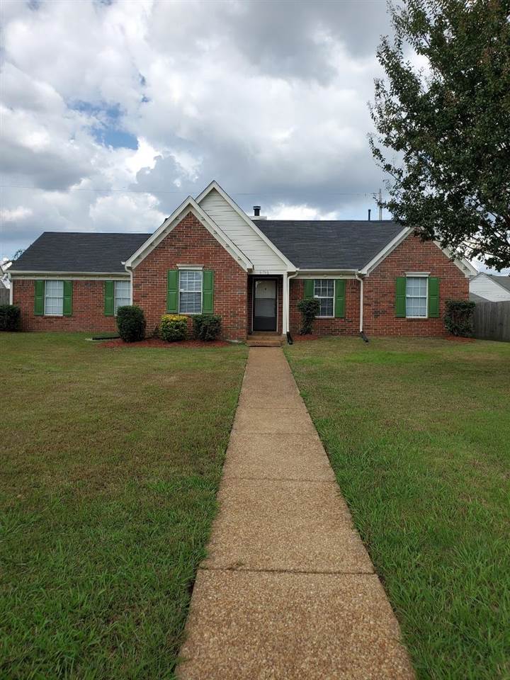 6748 State Line Road Memphis, TN 38141 - Photo 1 of 14 a front view of a house with yard