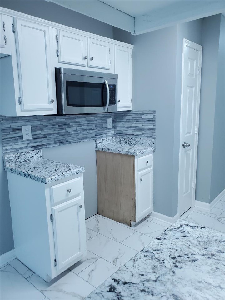 6748 State Line Road Memphis, TN 38141 - Photo 5 of 14 a kitchen with granite countertop white cabinets and white stainless steel appliances