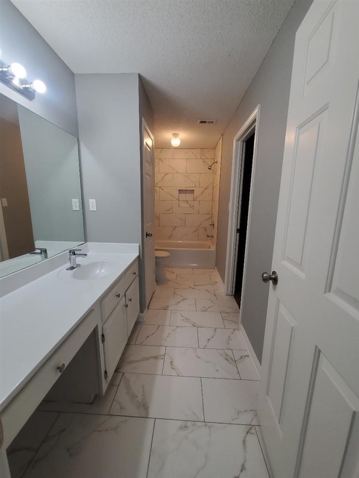 6748 State Line Road Memphis, TN 38141 - Photo 7 of 14 a bathroom with a double vanity sink toilet and shower